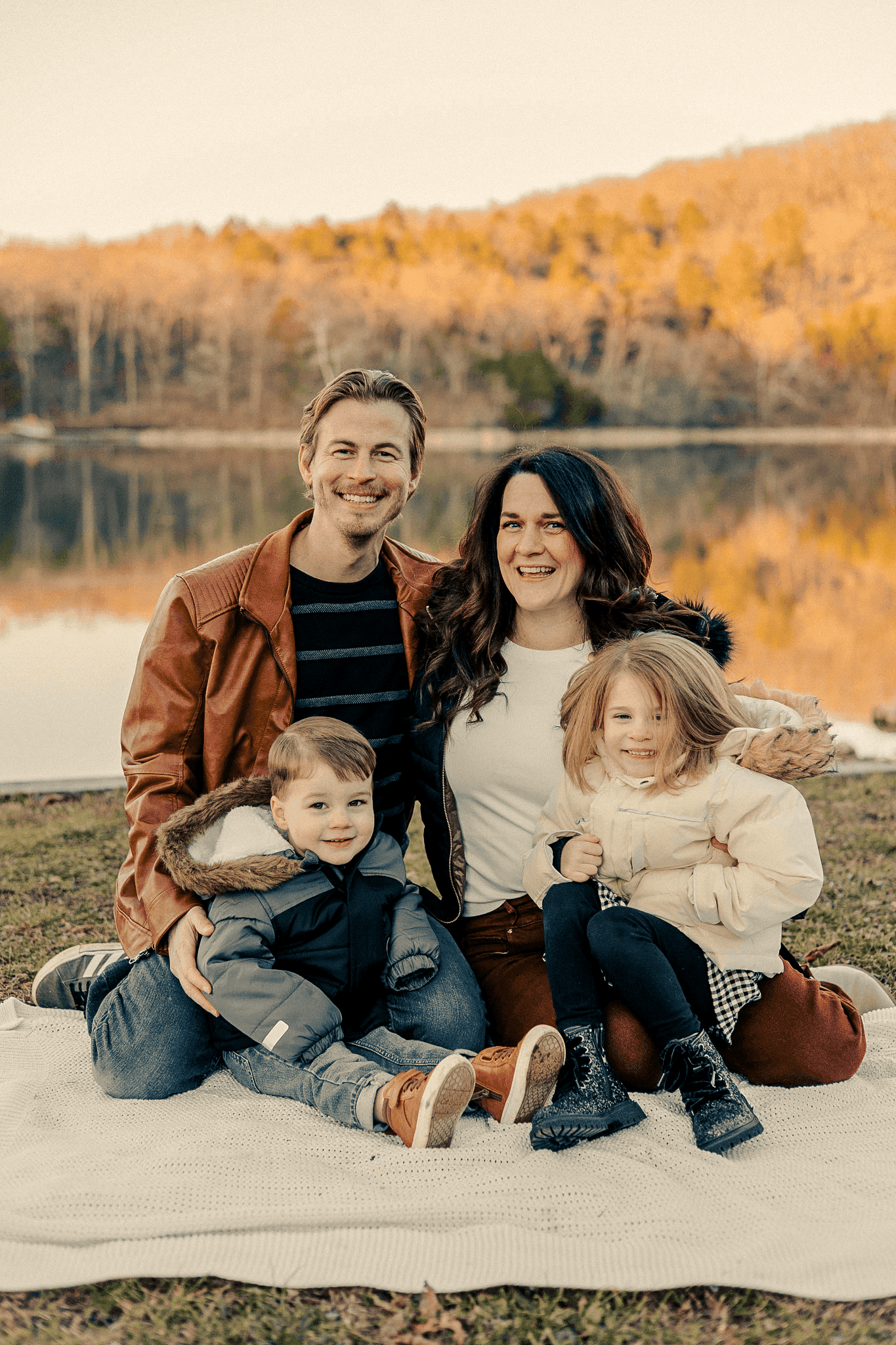 The founder with his family outdoors beside a lake